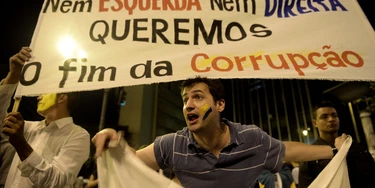 Demostrators stage a protest in front of policemen against corruption and price hikes in Belo Horizonte, Brazil on June 22, 2013. Brazil girded for more street protests Saturday despite President Dilma Rousseff's conciliatory remarks pledging to improve public services and fight corruption, while warning against further violence. Her speech came a day after more than one million people marched in cities across the country to slam the huge cost of hosting next June's World Cup, put at some 15 billion dollars, while public services such as schools and hospitals are lacking.    AFP PHOTO / Yuri CORTEZ        (Photo credit should read YURI CORTEZ/AFP/Getty Images)