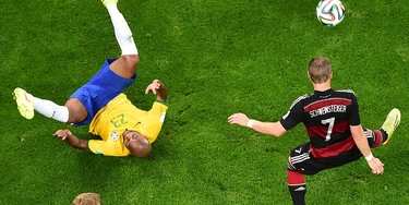 Germany's midfielder Bastian Schweinsteiger (R) controls the ball during the semi-final football match between Brazil and Germany at The Mineirao Stadium in Belo Horizonte during the 2014 FIFA World Cup on July 8, 2014. AFP PHOTO / POOL /  FRANCOIS XAVIER MARIT        (Photo credit should read FRANCOIS XAVIER MARIT/AFP/Getty Images)