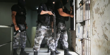 SAO LUIS, BRAZIL - JANUARY 27:  Miltary Police (PM) patrol in the Pedrinhas Prison Complex, the largest penitentiary in Maranhao state, on January 27, 2015 in Sao Luis, Brazil. Previously one of the most violent prisons in Brazil, Pedrinhas has seen efforts from a new state administration, new prison officials and judiciary leaders from Maranhao which appear to have quelled some of the unrest within the complex. In 2013, nearly 60 inmates were killed within the complex, including three who were beheaded during rioting. Much of the violence stemmed from broken cells allowing inmates and gang rivals to mix in the patios and open spaces of the complex. Officials recently repaired and repopulated the cells allowing law enforcement access and decreasing violence among prisoners, according to officials. Other reforms include a policy of custody hearings and real-time camera feeds. According to officials there have been no prisoner on prisoner killings inside the complex in nearly four months. Critics believe overcrowding is one of the primary causes of rioting and violence in Brazil's prisons. Additionally, overcrowding has strengthened prison gangs which now span the country and contol certain peripheries of cities including Rio de Janeiro, Sao Paulo and Sao Luis. Brazil now has the fourth-largest prison population in the world behind the U.S., Russia and China. The population of those imprisoned had quadrupled in the past twenty years to around 550,000 and the country needs at least 200,000 new incarceration spaces to eliminate overcrowding. A vast increase in minor drug arrests, a dearth of legal advice for prisoners and a lack of political will for new prisons have contributed to the increases.  (Photo by Mario Tama/Getty Images)