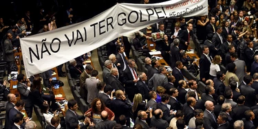 Brazilian pro-government deputies hold a banner reading "There will not be a coup" during the election of members for a special congressional commission that will be first up to analyze the impeachment case against President Dilma Rousseff, at the National Congress in Brasilia, on December 8, 2015. Pro-impeachment deputies got 39 out of 65 seats on the commission, which is tasked with making a recommendation to the full lower house on Rousseff's impeachment. AFP PHOTO/EVARISTO SA / AFP / EVARISTO SA        (Photo credit should read EVARISTO SA/AFP/Getty Images)