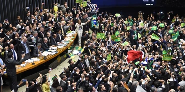 TOPSHOT - Brazil's lawmakers celebrate after they reached the votes needed to authorize President Dilma Rousseff's impeachment to go ahead, at the Congress in Brasilia on April 17, 2016.
Brazilian lawmakers on Sunday reached the two thirds majority necessary to authorize impeachment proceedings against President Dilma Rousseff. The lower house vote sends Rousseff's case to the Senate, which can vote to open a trial. A two thirds majority in the upper house would eject her from office. Rousseff, whose approval rating has plunged to a dismal 10 percent, faces charges of embellishing public accounts to mask the budget deficit during her 2014 reelection. / AFP / EVARISTO SA        (Photo credit should read EVARISTO SA/AFP/Getty Images)