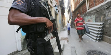 RIO DE JANEIRO, BRAZIL - JULY 26:  A UPP (Pacifying Police Unit) officer patrols in the Babilonia favela community, which stands on a hillside above Copacabana beach, an Olympic venue site, on July 26, 2016 in Rio de Janeiro, Brazil. A wave of violence has swept into some of Rio's 'pacified' favelas in recent months in the midst of a hard-hitting economic recession and fights between drug gangs and police. There are ten days to go before the start of the Rio 2016 Olympic Games,  (Photo by Mario Tama/Getty Images) RIO DE JANEIRO, BRAZIL - JULY 26:  A UPP (Pacifying Police Unit) officer patrols in the Babilonia favela community, which stands on a hillside above Copacabana beach, an Olympic venue site, on July 26, 2016 in Rio de Janeiro, Brazil. A wave of violence has swept into some of Rio's 'pacified' favelas in recent months in the midst of a hard-hitting economic recession and fights between drug gangs and police. There are ten days to go before the start of the Rio 2016 Olympic Games,  (Photo by Mario Tama/Getty Images)
