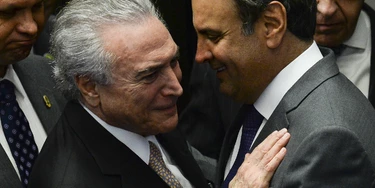 President Michel Temer (L) speaks with senator Aecio Neves before taking office before the plenary of the Brazilian Senate in Brasilia, on August 31, 2016. 
Brazil's Dilma Rousseff was stripped of the country's presidency in an impeachment vote Wednesday and replaced by her bitter rival Michel Temer, shifting Latin America's biggest economy sharply to the right. / AFP PHOTO / ANDRESSA ANHOLETE        (Photo credit should read ANDRESSA ANHOLETE/AFP/Getty Images)