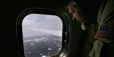 Lyn Lohberger of NASA looks out as sea ice floats near the coast of West Antarctica from a window of a NASA Operation IceBridge airplane on October 27, 2016 in-flight over Antarctica. NASA's Operation IceBridge has been studying how polar ice has evolved over the past eight years. Researchers have used the IceBridge data to observe that the West Antarctic Ice Sheet may be in a state of irreversible decline directly contributing to rising sea levels. 