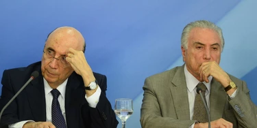 Brazilian President Michel Temer (R) and Finance Minister Henrique Meirelles (L) gesture during the announcement of new measures to stimulate the economy, in the Planalto Palace on December 15, 2016 in Brasilia. / AFP / ANDRESSA ANHOLETE        (Photo credit should read ANDRESSA ANHOLETE/AFP/Getty Images)