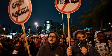 Demonstrators take part in a national strike against a labour and social welfare reform bill that the government of President Michel Temer intends to pass, in Sao Paulo, Brazil, on April 28, 2017.Major transportation networks schools and banks were partially shut down across much of Brazil on Friday in what protesters called a general strike against austerity reforms in Latin America's biggest country. / AFP PHOTO / NELSON ALMEIDA (Photo credit should read NELSON ALMEIDA/AFP/Getty Images) Demonstrators take part in a national strike against a labour and social welfare reform bill that the government of President Michel Temer intends to pass, in Sao Paulo, Brazil, on April 28, 2017.Major transportation networks schools and banks were partially shut down across much of Brazil on Friday in what protesters called a general strike against austerity reforms in Latin America's biggest country. / AFP PHOTO / NELSON ALMEIDA (Photo credit should read NELSON ALMEIDA/AFP/Getty Images)