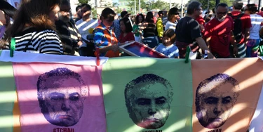 Demonstrators protest against labor and security reforms and the government of President Michel Temer in Sao Paulo Brazil on June 4, 2017. Brazil's Michel Temer may already be fighting a devastating corruption scandal, but this week he will face a more immediate threat: a court ruling on whether he should even be president. The Supreme Electoral Tribunal (TSE) case alleges that the reelection victory in 2014 of president Dilma Rousseff and her then vice president Temer was fatally tainted by illegal campaign funds and other irregularities and therefore should be annulled. / AFP PHOTO / NELSON ALMEIDA (Photo credit should read NELSON ALMEIDA/AFP/Getty Images) Demonstrators protest against labor and security reforms and the government of President Michel Temer in Sao Paulo Brazil on June 4, 2017. Brazil's Michel Temer may already be fighting a devastating corruption scandal, but this week he will face a more immediate threat: a court ruling on whether he should even be president. The Supreme Electoral Tribunal (TSE) case alleges that the reelection victory in 2014 of president Dilma Rousseff and her then vice president Temer was fatally tainted by illegal campaign funds and other irregularities and therefore should be annulled. / AFP PHOTO / NELSON ALMEIDA (Photo credit should read NELSON ALMEIDA/AFP/Getty Images)