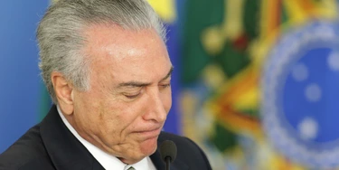 Brazil's acting President Michel Temer attends a ceremony on student financing, at the Planalto presidential palace, in Brasilia, Brazil, Thursday, June 16, 2016. Brazil's acting President Michel Temer rejected allegations that represented the first direct link between him and the massive corruption probe at the state-run oil company Petrobras, denying that he sought campaign funds for his party's mayoral candidate in Sao Paulo as part of a kickback scheme. (AP Photo/Eraldo Peres)
