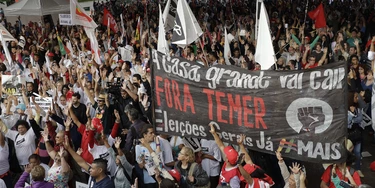 Demonstrators holding a banner that reads in Portuguese " Temer Out, general elections now" attend a protest against Brazil's President Michel Temerin Sao Paulo, Brazil, Thursday, Sept. 22, 2016. Temer became Brazil's president following the ouster of Dilma Rousseff by the Senate over accusations of fiscal mismanagement. (AP Photo/Andre Penner)