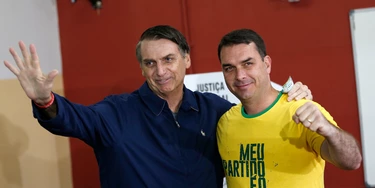 FILE - In this Oct. 7, 2018 file photo, then presidential frontrunner Jair Bolsonaro, left, and his son Flavio, acknowledge reporters at a polling station in Rio de Janeiro, Brazil. The son of Brazilian President-elect Jair Bolsonaro is denying wrongdoing in a case involving suspect bank transactions. According to a recent Financial Activities Control Council report, Flavio Bolsonaro's driver deposited various amounts between January 2016 and January 2017. On Thursday, Dec. 13, 2018, Flavio Bolsonaro posted on Twitter that he had “done nothing wrong.” (AP Photo/Silvia Izquierdo, File) FILE - In this Oct. 7, 2018 file photo, then presidential frontrunner Jair Bolsonaro, left, and his son Flavio, acknowledge reporters at a polling station in Rio de Janeiro, Brazil. The son of Brazilian President-elect Jair Bolsonaro is denying wrongdoing in a case involving suspect bank transactions. According to a recent Financial Activities Control Council report, Flavio Bolsonaro's driver deposited various amounts between January 2016 and January 2017. On Thursday, Dec. 13, 2018, Flavio Bolsonaro posted on Twitter that he had “done nothing wrong.” (AP Photo/Silvia Izquierdo, File)