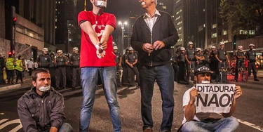 SAO PAOLO, BRAZIL - JUNE 26, 2014 - Some group members use tape on their mouths to simulate censorship matter by the Brazilian military police to protesters against the World Cup in the country. A group of protesters contraries the World Cup protests against the arrest of two militants held on Monday, in São Paulo, Brazil. Inrregular considered by the group, about 300 people stopped traffic on the main avenue of the city pendindo freedom of prisoners and the demilitarization of the police in Sao Paulo. (Photo by Taba Benedicto/NurPhoto/Sipa USA) SAO PAOLO, BRAZIL - JUNE 26, 2014 - Some group members use tape on their mouths to simulate censorship matter by the Brazilian military police to protesters against the World Cup in the country. A group of protesters contraries the World Cup protests against the arrest of two militants held on Monday, in São Paulo, Brazil. Inrregular considered by the group, about 300 people stopped traffic on the main avenue of the city pendindo freedom of prisoners and the demilitarization of the police in Sao Paulo. (Photo by Taba Benedicto/NurPhoto/Sipa USA)