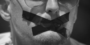 A members of the foreign media wears black tape across his mouth, to signify the silencing of the media, at a demonstration by Kenyan and Nairobi-based foreign media calling for the release in Egypt of detained Al Jazeera journalist Peter Greste and his colleagues, in Nairobi, Kenya Thursday, Feb. 27, 2014. The protest, part of a global day of action in support of press freedom, called for all journalists jailed in Egypt to be freed but focused attention in particular on Greste, a Nairobi-based correspondent for Al Jazeera who has been in custody in Egypt since Dec. 29, 2013. (AP Photo/Ben Curtis)