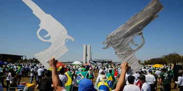 TOPSHOT - A man holds two signals in the shape of a gun during a pro-gun demonstration in support of Brazilian President Jair Bolsonaro in Brasilia, on July 9, 2021. (Photo by Sergio Lima / AFP) (Photo by SERGIO LIMA/AFP via Getty Images) TOPSHOT - A man holds two signals in the shape of a gun during a pro-gun demonstration in support of Brazilian President Jair Bolsonaro in Brasilia, on July 9, 2021. (Photo by Sergio Lima / AFP) (Photo by SERGIO LIMA/AFP via Getty Images)