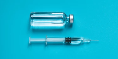 Syringe and ampoule on blue background Syringe and ampoule on blue background