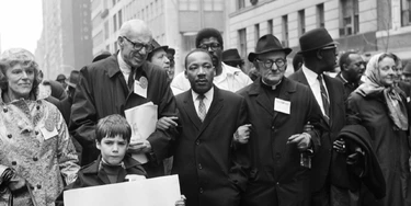 NEW YORK, UNITED STATES:  Civil rights leader Rev. Martin Luther King, Jr., (C) is accompanied by famed pediatrician Dr. Benjamin Spock (2nd-L), Father Frederick Reed (3rd-R) and union leader Cleveland Robinson (2nd-R) 16 March, 1967, during an anti-Vietnam War demonstration in New York. The US is celebrating in 2004 what would have been King's 75th birthday. King was assassinated on 04 April, 1968, in Memphis, Tennessee. AFP PHOTO (Photo credit should read AFP/AFP/Getty Images)