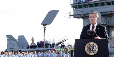 USS ABRAHAM LINCOLN, AT SEA: (FILES) -- A file photo taken 01 May 2003 shows US President George W. Bush addressing the nation aboard the nuclear aircraft carrier USS Abraham Lincoln as it sails for Naval Air Station North Island, San Diego, California. Four years after the US-led invasion of Iraq, commanders are in fact pouring 25,000 reinforcements into Baghdad to quell Sunni-Shiite fighting, the bloodiest element of the conflict and one which even the Pentagon admits now amounts to civil war. AFP Photo / Stephen JAFFE (Photo credit should read STEPHEN JAFFE/AFP/Getty Images) USS ABRAHAM LINCOLN, AT SEA: (FILES) -- A file photo taken 01 May 2003 shows US President George W. Bush addressing the nation aboard the nuclear aircraft carrier USS Abraham Lincoln as it sails for Naval Air Station North Island, San Diego, California. Four years after the US-led invasion of Iraq, commanders are in fact pouring 25,000 reinforcements into Baghdad to quell Sunni-Shiite fighting, the bloodiest element of the conflict and one which even the Pentagon admits now amounts to civil war. AFP Photo / Stephen JAFFE (Photo credit should read STEPHEN JAFFE/AFP/Getty Images)