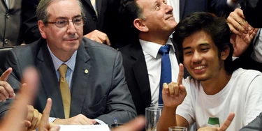 Kim Kataguiri (R), leader of the Free Brazil Movement (MBL), meets with Brazilian Lower House President Eduardo Cunha in Brasilia, Brazil on May 27, 2015. Kataguiri, a 19-year-old college drop out, is the face of MBL, a growing force which seeks to harness some of the energy of the 2013 protest movement which brought more than a million onto the streets. AFP PHOTO/EVARISTO SA (Photo credit should read EVARISTO SA/AFP/Getty Images) Kim Kataguiri (R), leader of the Free Brazil Movement (MBL), meets with Brazilian Lower House President Eduardo Cunha in Brasilia, Brazil on May 27, 2015. Kataguiri, a 19-year-old college drop out, is the face of MBL, a growing force which seeks to harness some of the energy of the 2013 protest movement which brought more than a million onto the streets. AFP PHOTO/EVARISTO SA (Photo credit should read EVARISTO SA/AFP/Getty Images)