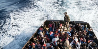 A Libyan coast guardsman stands on a boat during the rescue of 147 illegal immigrants attempting to reach Europe off the coastal town of Zawiyah, 45 kilometres west of the capital Tripoli, on June 27, 2017.More than 8,000 migrants have been rescued in waters off Libya during the past 48 hours in difficult weather conditions, Italy's coastguard said on June 27, 2017. / AFP PHOTO / Taha JAWASHI (Photo credit should read TAHA JAWASHI/AFP/Getty Images) A Libyan coast guardsman stands on a boat during the rescue of 147 illegal immigrants attempting to reach Europe off the coastal town of Zawiyah, 45 kilometres west of the capital Tripoli, on June 27, 2017.More than 8,000 migrants have been rescued in waters off Libya during the past 48 hours in difficult weather conditions, Italy's coastguard said on June 27, 2017. / AFP PHOTO / Taha JAWASHI (Photo credit should read TAHA JAWASHI/AFP/Getty Images)