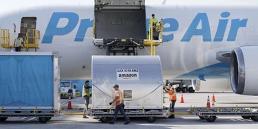 Trabalhadores colocam carga em uma aeronave Amazon Prime Air no Air Hub da empresa no Aeroporto Internacional de Cincinnati, no estado americano de Kentucky, em 11 de outubro de 2021.