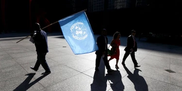 A protester is silhouetted as he carries the United Nations flag during a rally against Nigerian President Buhari as pedestrians walk through federal plaza Wednesday, Sept. 20, 2017, in Chicago. (AP Photo/Charles Rex Arbogast) A protester is silhouetted as he carries the United Nations flag during a rally against Nigerian President Buhari as pedestrians walk through federal plaza Wednesday, Sept. 20, 2017, in Chicago. (AP Photo/Charles Rex Arbogast)
