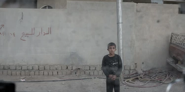A young boy stares at the photographer through the window of an Iraqi army Humvee in the Karkukli neighborhood of Mosul, Iraq on Nov. 17, 2016. A young boy stares at the photographer through the window of an Iraqi army Humvee in the Karkukli neighborhood of Mosul, Iraq on Nov. 17, 2016.