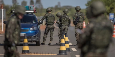 Members of the Brazilian Army check vehicles traveling along BR 174 highway, often used by Venezuelans seeking shelter in Brazil, in Pacaraima, Roraima state, Brazil, on Tuesday, Feb. 20, 2018.