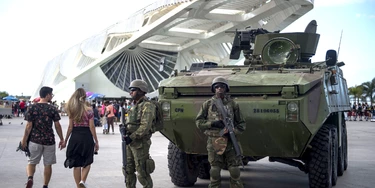 Brazilian marines with armoured personnel carriers (APC) stand guard at the Museum of Tomorrow area in the portuary zone of Rio de Janeiro, Brazil, on July 29, 2017. Brazil has mobilized some 8,500 soldiers to Rio de Janeiro state to fight organized crime and a spike in street violence. President Michel Temer signed a decree allowing the use of the armed forces in Rio de Janeiro state, the official government gazette announced. / AFP PHOTO / Mauro PIMENTEL (Photo credit should read MAURO PIMENTEL/AFP/Getty Images) Brazilian marines with armoured personnel carriers (APC) stand guard at the Museum of Tomorrow area in the portuary zone of Rio de Janeiro, Brazil, on July 29, 2017. Brazil has mobilized some 8,500 soldiers to Rio de Janeiro state to fight organized crime and a spike in street violence. President Michel Temer signed a decree allowing the use of the armed forces in Rio de Janeiro state, the official government gazette announced. / AFP PHOTO / Mauro PIMENTEL (Photo credit should read MAURO PIMENTEL/AFP/Getty Images)