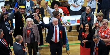 Britain's Labour party leader Jeremy Corbyn, bottom center, waves after arriving for the declaration at his constituency in London, Friday, June 9, 2017. Britain voted Thursday in an election that started out as an attempt by Prime Minister Theresa May to increase her party's majority in Parliament ahead of Brexit negotiations but was upended by terror attacks in Manchester and London during the campaign's closing days. (AP Photo/Frank Augstein) Britain's Labour party leader Jeremy Corbyn, bottom center, waves after arriving for the declaration at his constituency in London, Friday, June 9, 2017. Britain voted Thursday in an election that started out as an attempt by Prime Minister Theresa May to increase her party's majority in Parliament ahead of Brexit negotiations but was upended by terror attacks in Manchester and London during the campaign's closing days. (AP Photo/Frank Augstein)