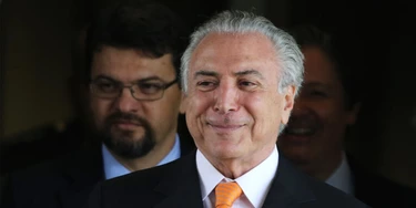 Brazil’s Vice President Michel Temer talks with journalists as he leaves his office at Planalto presidential palace in Brasilia, Brazil, Wednesday, Dec. 9, 2015. A private letter from Temer to President Dilma Rousseff shook the country on Tuesday, revealing differences between them at a time when the president is facing possible impeachment. The letter was published in Brazil's newspaper O Globo. (AP Photo/Eraldo Peres)