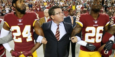 Washington Redskins Owner Daniel Synder stands with cornerback Josh Norman (24) and cornerback Bashaud Breeland (26) during the the national anthem before the NFL football game against the Oakland Raiders at FedExField on Sept. 24, 2017 in Landover, Md. Washington Redskins Owner Daniel Synder stands with cornerback Josh Norman (24) and cornerback Bashaud Breeland (26) during the the national anthem before the NFL football game against the Oakland Raiders at FedExField on Sept. 24, 2017 in Landover, Md.