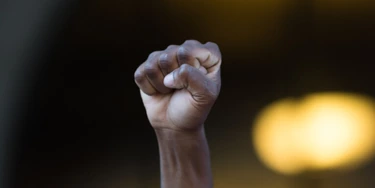 Los Angeles, USA - July 12, 2016 - Black lives matter protestor put their fists in the air as a sign of 'black power' on City Hall following ruling on LAPD fatal shooting of African American female Redel Jones Los Angeles, USA - July 12, 2016 - Black lives matter protestor put their fists in the air as a sign of 'black power' on City Hall following ruling on LAPD fatal shooting of African American female Redel Jones