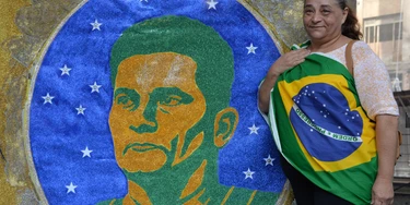 A woman stands next to an image of Brazilian judge Sergio Moro during a protest against suspended president Dilma Rousseff in Sao Paulo, on July 31, 2016.Protesters took to the streets of Brazil on Sunday to demand the final leaving of suspended President Dilma Rousseff or to defend her continuance, just five days before the start of the Rio 2016 Olympic Games. / AFP / NELSON ALMEIDA (Photo credit should read NELSON ALMEIDA/AFP/Getty Images) A woman stands next to an image of Brazilian judge Sergio Moro during a protest against suspended president Dilma Rousseff in Sao Paulo, on July 31, 2016.Protesters took to the streets of Brazil on Sunday to demand the final leaving of suspended President Dilma Rousseff or to defend her continuance, just five days before the start of the Rio 2016 Olympic Games. / AFP / NELSON ALMEIDA (Photo credit should read NELSON ALMEIDA/AFP/Getty Images)