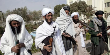 HERAT, AFGHANISTAN - NOVEMBER 4: Surrendering Taliban militants stand with their weapons as they are presented to the media on November 4, 2010 in Herat, Afghanistan. Twenty Taliban fighters from Afghanistan's Herat province have surrendered to government troops in Herat, west of the capital city of Kabul. After an amnesty launched by President Hamid Karzai in November 2004, hundreds of anti-government Taliban militants have since surrendered to the government. (Photo by Majid Saeedi/Getty Images) HERAT, AFGHANISTAN - NOVEMBER 4: Surrendering Taliban militants stand with their weapons as they are presented to the media on November 4, 2010 in Herat, Afghanistan. Twenty Taliban fighters from Afghanistan's Herat province have surrendered to government troops in Herat, west of the capital city of Kabul. After an amnesty launched by President Hamid Karzai in November 2004, hundreds of anti-government Taliban militants have since surrendered to the government. (Photo by Majid Saeedi/Getty Images)