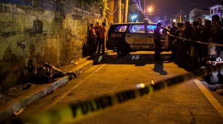 A dead body is revealed as police shine their flashlights during an investigation of a crime scene in Manadaluyong city . The killing was allegedly perpetrated by masked vigilantes who hogtied the victim before he was shot.

copyright 2017 Luis Liwanag