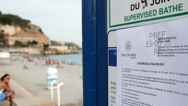 This picture taken on August 19, 2016 shows the bylaw forbidding women to wear Burkini at the beach in Nice, southeastern France on August 19, 2016. 
Nice has become the latest French seaside resort to ban the burkini, the body-concealing Islamic swimsuit that has sparked heated debate in secular France. Using language similar to bans imposed in a string of other towns on the French Riviera, the city barred apparel that "overtly manifests adherence to a religion at a time when France and places of worship are the target of terrorist attacks".
 / AFP / JEAN CHRISTOPHE MAGNENET        (Photo credit should read JEAN CHRISTOPHE MAGNENET/AFP/Getty Images)