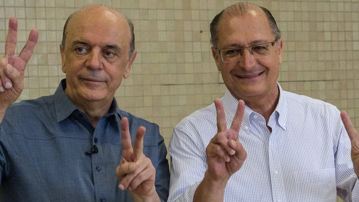 Sao Paulo state governor Geraldo Alckmin(R) poses with the mayoral candidate of the Brazilian Social Democracy Party (PSDB), Jose Serra (L), after casting his vote in Sao Paulo, Brazil on October 07, 2012. Brazilians trooped to the polls early Sunday to vote in nationwide municipal elections seen as a key test of the ruling Workers Party's popularity ahead of the 2014 presidential elections. AFP PHOTO/YASUYOSHI CHIBA        (Photo credit should read YASUYOSHI CHIBA/AFP/GettyImages)
