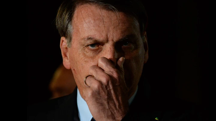 BRASILIA, BRAZIL - JUNE 05: President of Brazil Jair Bolsonaro reacts during a conference with the press and supporters  at Alvorada Palace on June 05, 2020 in Brasilia, Brazil. Brazil has over 614,000 confirmed positive cases of Coronavirus and OVER 34,000 deaths. (Photo by Andressa Anholete/Getty Images)