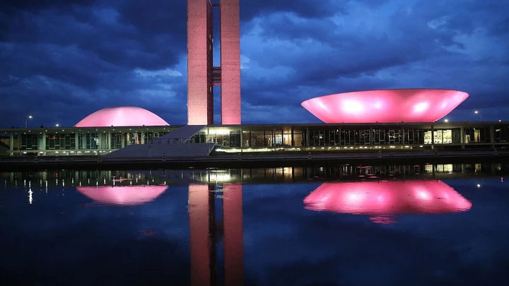 BRASILIA, BRAZIL - OCTOBER 27:  The Brazilian National Congress building is lit at dusk on October 27, 2014 in Brasilia, Brazil. Brazil's left-wing President Dilma Rousseff was narrowly re-elected yesterday and will serve another four years in Brazil's unique planned capital city. The modernist city was founded in 1960 and replaced Rio de Janeiro as the federal capital of Brazil. The city was designed by urban planner Lucio Costa and architect Oscar Niemeyer and is now a UNESCO World Hertiage site.  (Photo by Mario Tama/Getty Images)
