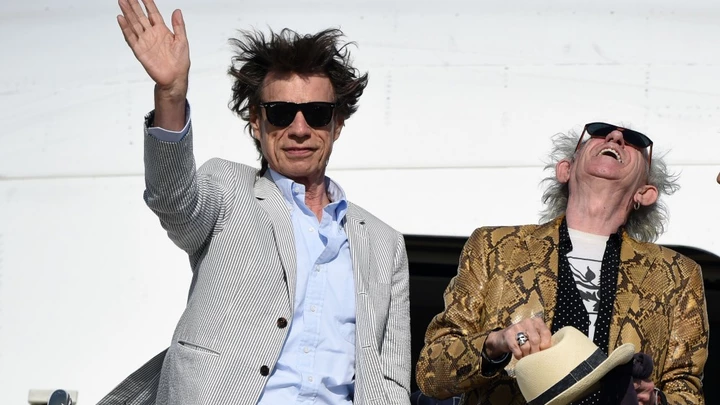 British The Rolling Stones' Mick Jagger waves next to Keith Richards upon arrival in Montevideo on February 15, 2016, on the eve of their presentation within the America Latina Ole Tour.   AFP PHOTO / PABLO PORCIUNCULA / AFP / PABLO PORCIUNCULA        (Photo credit should read PABLO PORCIUNCULA/AFP/Getty Images) British The Rolling Stones' Mick Jagger waves next to Keith Richards upon arrival in Montevideo on February 15, 2016, on the eve of their presentation within the America Latina Ole Tour.   AFP PHOTO / PABLO PORCIUNCULA / AFP / PABLO PORCIUNCULA        (Photo credit should read PABLO PORCIUNCULA/AFP/Getty Images)