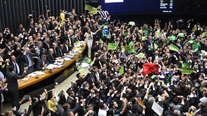 TOPSHOT - Brazil's lawmakers celebrate after they reached the votes needed to authorize President Dilma Rousseff's impeachment to go ahead, at the Congress in Brasilia on April 17, 2016.
Brazilian lawmakers on Sunday reached the two thirds majority necessary to authorize impeachment proceedings against President Dilma Rousseff. The lower house vote sends Rousseff's case to the Senate, which can vote to open a trial. A two thirds majority in the upper house would eject her from office. Rousseff, whose approval rating has plunged to a dismal 10 percent, faces charges of embellishing public accounts to mask the budget deficit during her 2014 reelection. / AFP / EVARISTO SA        (Photo credit should read EVARISTO SA/AFP/Getty Images)