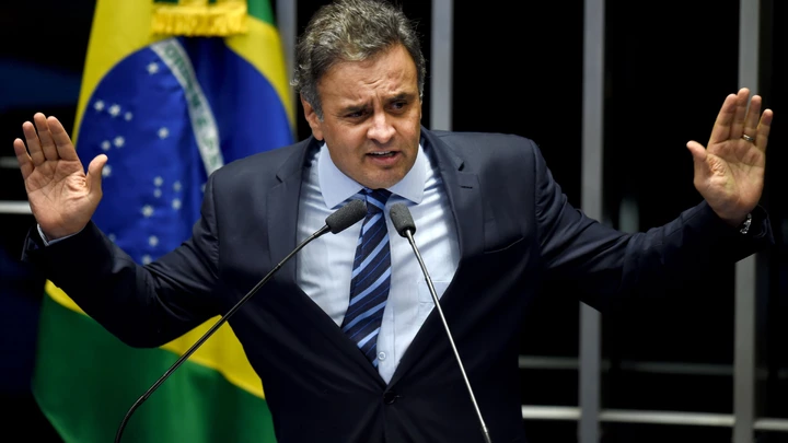 Brazilian senator Aecio Neves, from PSDB, delivers a speech during the debate in the Senate of a vote on suspending President Dilma Rousseff and launching an impeachment trial, in Brasilia on May 11, 2016. A simple majority in the 81-member Senate will trigger Rousseff's six-month suspension pending trial. A two-thirds majority would then be needed to remove her permanently. / AFP / EVARISTO SA (Photo credit should read EVARISTO SA/AFP/Getty Images)