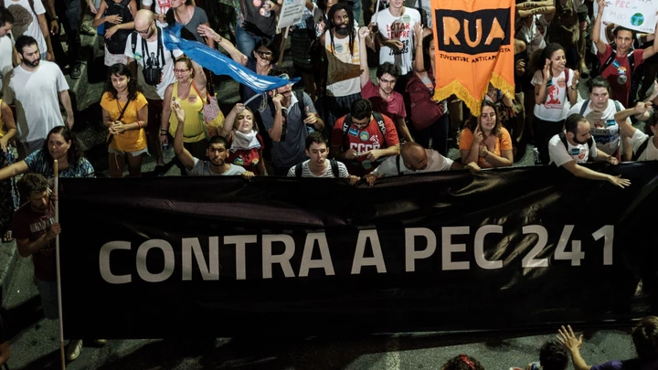 Opposers to President Michel Temer's economic recovery program, march against the constitutional amendment (PEC) 241, in Rio de Janeiro, Brazil, on October 17, 2016.Approved by Brazils lower house, the constitutional amendment limits budget increases to the rate of inflation for the next 20 years. Leftist lawmakers had fought against the spending cap, arguing that it would dramatically worsen conditions for ordinary Brazilians, especially the poor. / AFP / YASUYOSHI CHIBA (Photo credit should read YASUYOSHI CHIBA/AFP/Getty Images) Opposers to President Michel Temer's economic recovery program, march against the constitutional amendment (PEC) 241, in Rio de Janeiro, Brazil, on October 17, 2016.Approved by Brazils lower house, the constitutional amendment limits budget increases to the rate of inflation for the next 20 years. Leftist lawmakers had fought against the spending cap, arguing that it would dramatically worsen conditions for ordinary Brazilians, especially the poor. / AFP / YASUYOSHI CHIBA (Photo credit should read YASUYOSHI CHIBA/AFP/Getty Images)