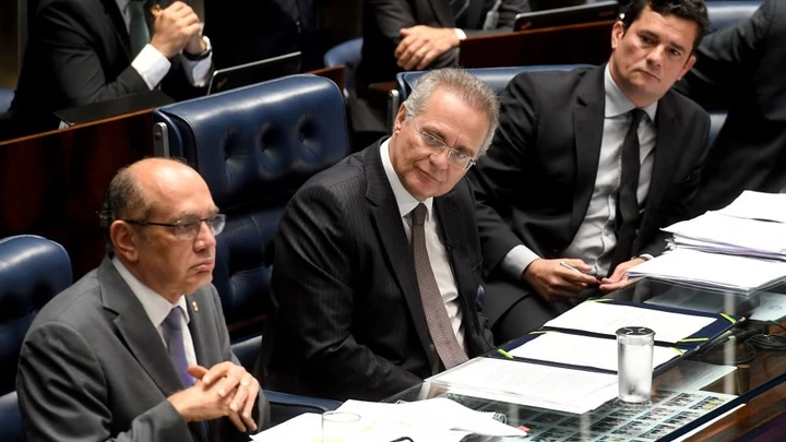Supreme Court's Judge Gilmar Mendes (L), Senate's President Renan Calheiros (C) and Federal Judge Sergio Moro attend a public hearing on the bill that establishes the abuse of authority for judges and prosecutors, in the Senate in Brasilia on December 1, 2016.Even with a strong reaction against the bill from the public, Calheiros tries to speed up approval in the Senate and Lower House. The controversial law is ostensibly meant to crack down on undeclared election campaign funds, a common practice in Brazilian politics that has been linked to large-scale corruption. Judges and prosecutors have branded this as a weapon to reduce the judiciary's independence. / AFP / EVARISTO SA (Photo credit should read EVARISTO SA/AFP/Getty Images)