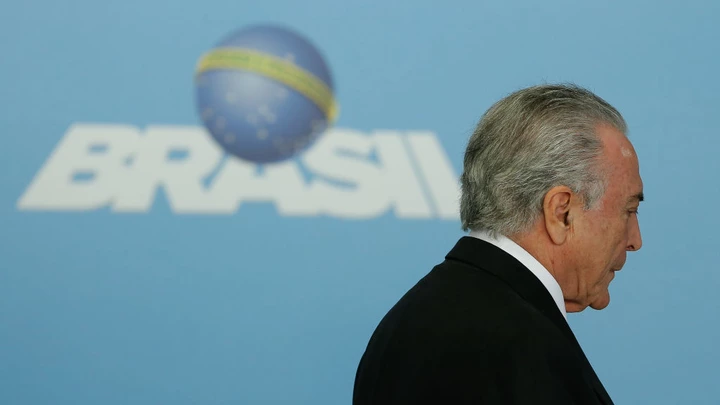 Brazil's President Michel Temer arrives for a ceremony to announce the airports' franchise programme, at the Planalto Palace in Brasilia, Brazil on July 27, 2017. 
Brazilian President Michel Temer's popularity fell from 10 percent in March to a meager 5 percent, according to a poll released on Thursday in the prelude to the voting at the Chamber of Deputies to decide if a corruption report against the conservative leader advances to the supreme court. / AFP PHOTO / Sergio LIMA        (Photo credit should read SERGIO LIMA/AFP/Getty Images) Brazil's President Michel Temer arrives for a ceremony to announce the airports' franchise programme, at the Planalto Palace in Brasilia, Brazil on July 27, 2017. 
Brazilian President Michel Temer's popularity fell from 10 percent in March to a meager 5 percent, according to a poll released on Thursday in the prelude to the voting at the Chamber of Deputies to decide if a corruption report against the conservative leader advances to the supreme court. / AFP PHOTO / Sergio LIMA        (Photo credit should read SERGIO LIMA/AFP/Getty Images)