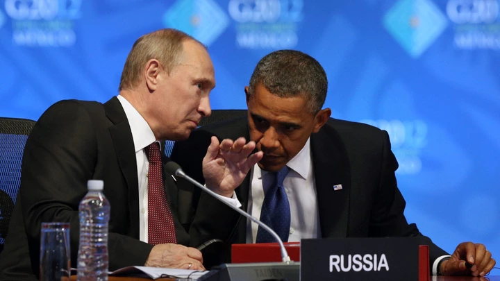 U.S. President Barack Obama, right, listens to Russia's President Vladimir Putin before the opening of the first plenary session of the G-20 Summit in Los Cabos, Mexico, Monday, June 18, 2012. (AP Photo/Andres Leighton)