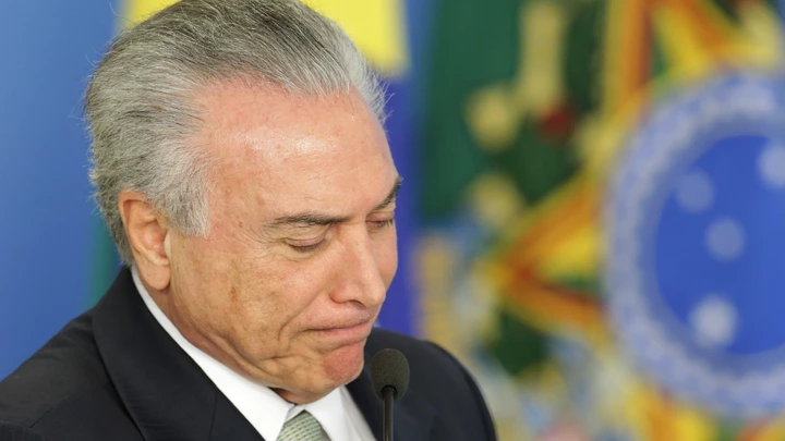 Brazil's acting President Michel Temer attends a ceremony on student financing, at the Planalto presidential palace, in Brasilia, Brazil, Thursday, June 16, 2016. Brazil's acting President Michel Temer rejected allegations that represented the first direct link between him and the massive corruption probe at the state-run oil company Petrobras, denying that he sought campaign funds for his party's mayoral candidate in Sao Paulo as part of a kickback scheme. (AP Photo/Eraldo Peres)