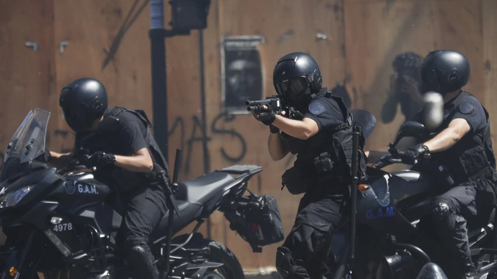 Motorized police fire rubber bullets at protesters during a general strike against a pension reform measure, outside Congress in Buenos Aires, Argentina, Monday, Dec. 18, 2017. Union leaders complain the legislation, which already passed in the Senate, would cut pension and retirement payments as well as aid for some of poor families. (AP Photo/Victor R. Caivano) Motorized police fire rubber bullets at protesters during a general strike against a pension reform measure, outside Congress in Buenos Aires, Argentina, Monday, Dec. 18, 2017. Union leaders complain the legislation, which already passed in the Senate, would cut pension and retirement payments as well as aid for some of poor families. (AP Photo/Victor R. Caivano)