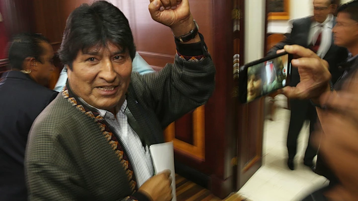 In this Nov. 27, 2019 photo, Bolivia's former President Evo Morales pumps his fist after a press conference at the journalists club in Mexico City. Morales went into exile in Mexico after he was prodded by police and the military, forcing him to resigned on Nov. 10, after he claimed victory in an election that international observers invited in by the government said was marred by numerous irregularities. (AP Photo/Marco Ugarte)