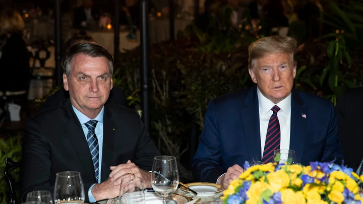 FILE - In this March 7, 2020, file photo President Donald Trump is seated before a dinner with Brazilian President Jair Bolsonaro, left, at Mar-a-Lago in Palm Beach, Fla. Bolsonaro’s communications director, Fábio Wajngarten, tested positive just days after traveling with Bolsonaro to a meeting with Trump and senior aides in Florida. (AP Photo/Alex Brandon, File) FILE - In this March 7, 2020, file photo President Donald Trump is seated before a dinner with Brazilian President Jair Bolsonaro, left, at Mar-a-Lago in Palm Beach, Fla. Bolsonaro’s communications director, Fábio Wajngarten, tested positive just days after traveling with Bolsonaro to a meeting with Trump and senior aides in Florida. (AP Photo/Alex Brandon, File)