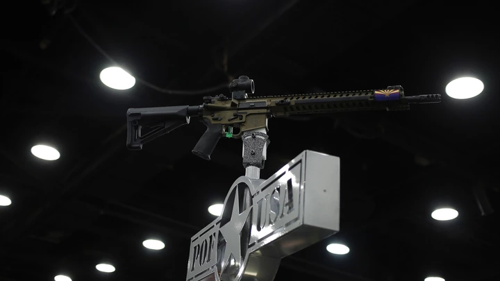 An AR-15 rifle is displayed on top of a booth on the exhibit floor during the National Rifle Association (NRA) annual meeting in Louisville, Kentucky, U.S., on Friday, May 20, 2016. The nation's largest gun lobby, the NRA has been a political force in elections since at least 1994, turning out its supporters for candidates who back expanding access to guns. Photographer: Luke Sharrett/Bloomberg via Getty Images